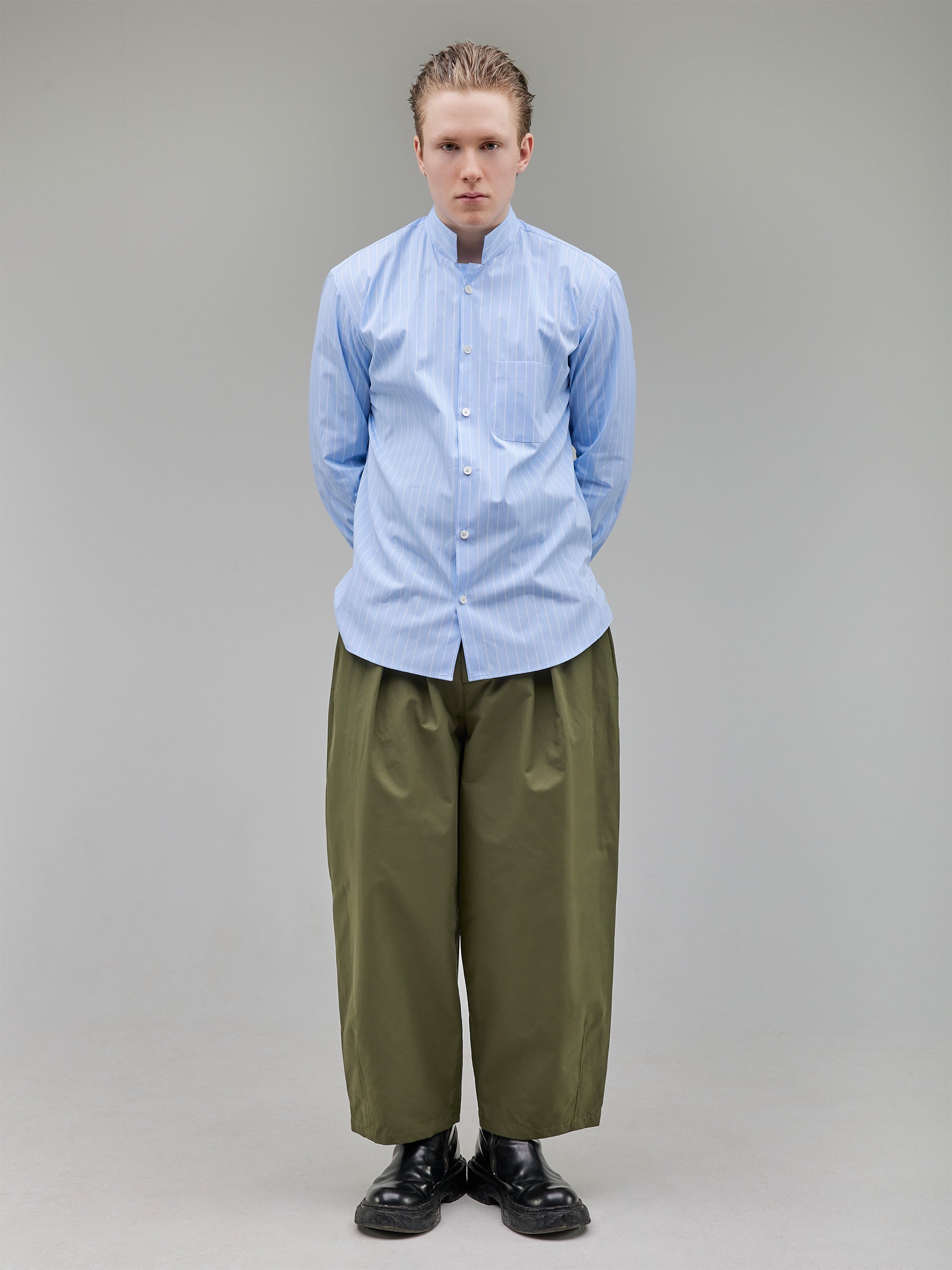 Regular-fit mandarin-collar shirt in baby blue with white stripes, offering a crisp yet relaxed silhouette.
Fabric: 100% Cotton
Buttons: White Trocas Mother of Pearl
Bottom: Tapered-leg trousers with a tailored waistband and clean pleating.